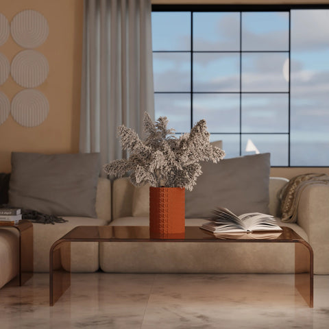 Modern living room with a sofa, coffee table, and decorative elements.